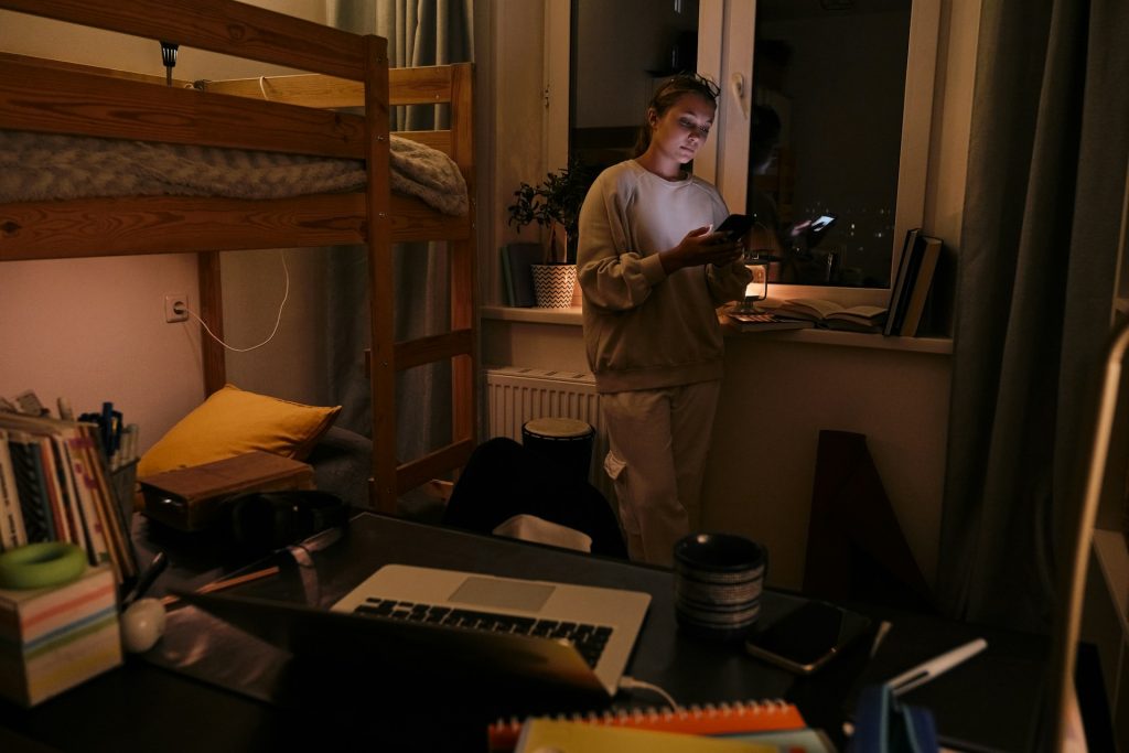 A woman standing using a phone