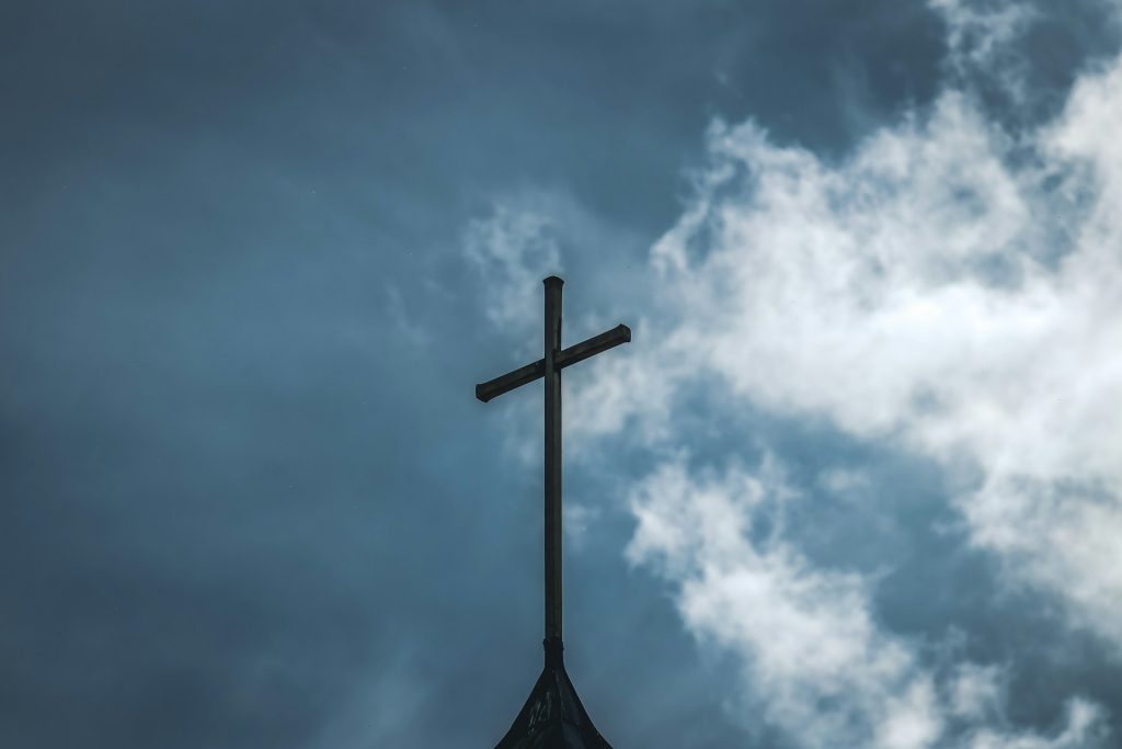 Cross against the sky representing the fruit of the Spirit, spiritual growth, grace, and heaven