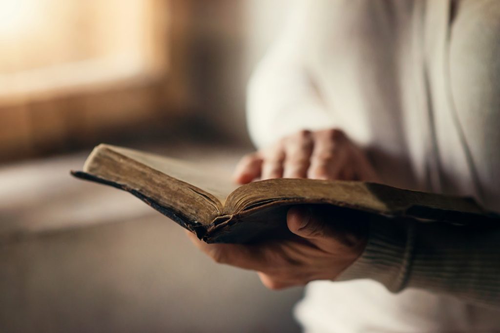 Open Bible representing the meaning of discernment and seeking God’s wisdom to separate truth from noise