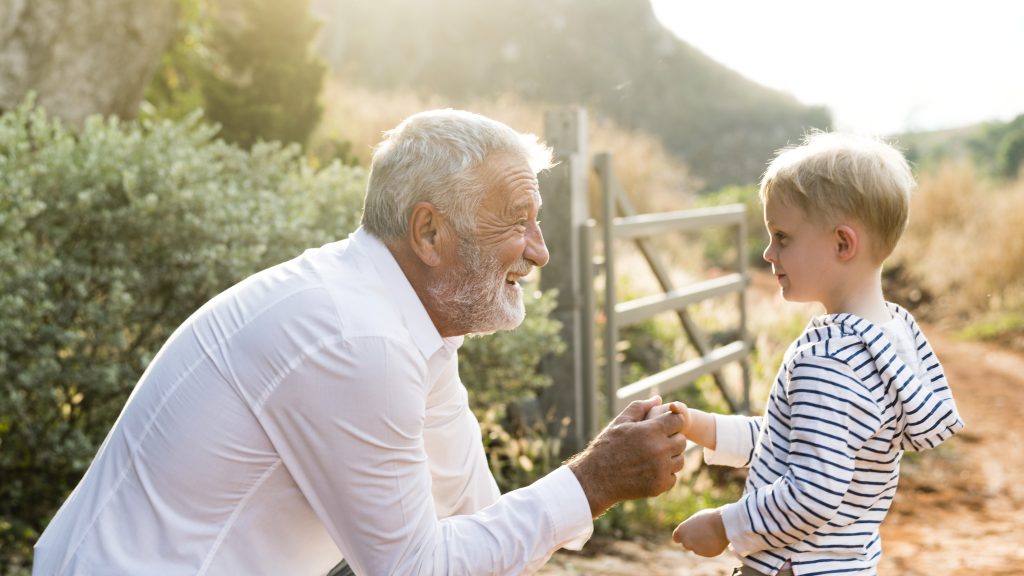 Grandparent and grandchild hands on a Bible — Bible verses about grandparents
