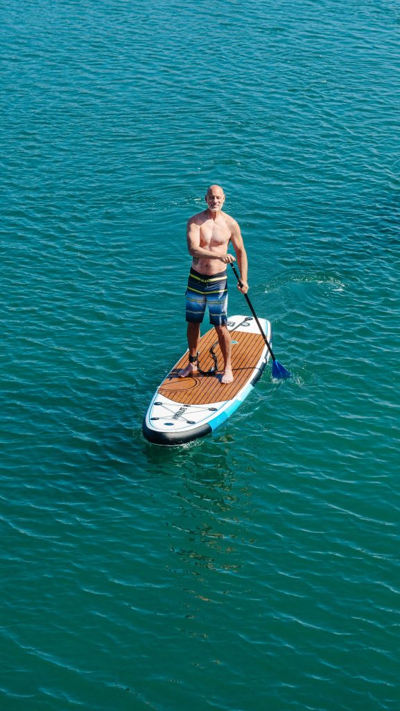 Person paddleboarding on calm water