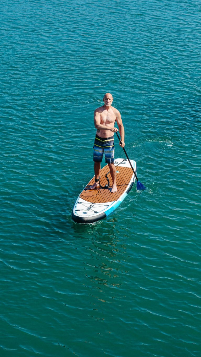 Person paddleboarding on calm water