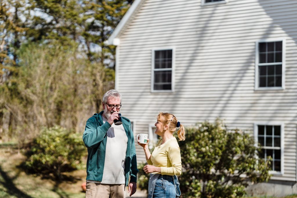 Neighbors talking over a fence in the afternoon — love your neighbor as yourself