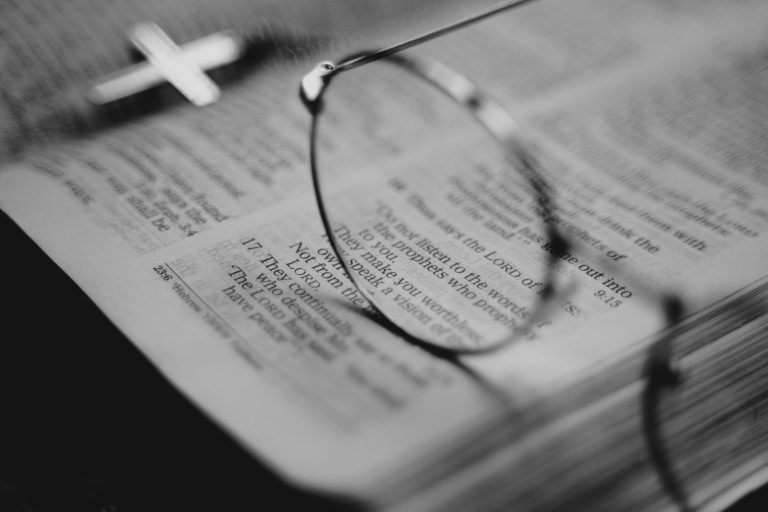 Reading glasses resting on an open Bible — wise as serpents and harmless as doves